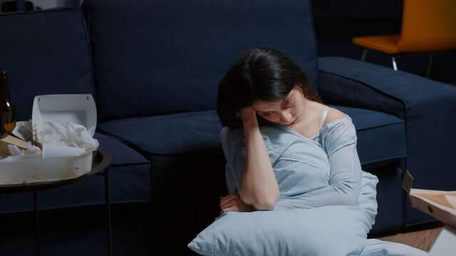 Traumatized shocked tierd unhappy woman sitting on floor thinking at problems, suffering from anxiety chronic disease insomnia mental problems suicidal thoughts feeling pain frustration disappointment