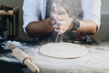 person kneading dough