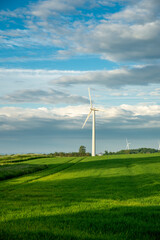 windmill, on green field, blue sky, white clouds