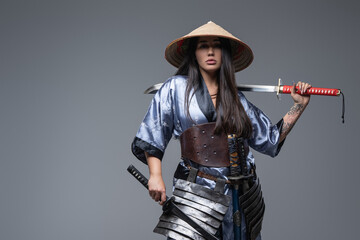 Fototapeta premium Asian woman with bamboo hat and katana