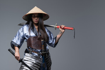Woman fighter from east holding katana on her shoulder © Fxquadro
