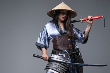 Woman fighter from east holding katana on her shoulder © Fxquadro