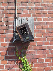 レンガの壁にある壊れた機械