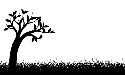 Silhouette tree standing alone on grass field with copy space for text