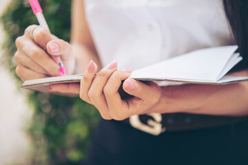 Portrait of asian student university uniform beautiful girl relax and smile. Asian girl in campus uniform reading in the library at campus