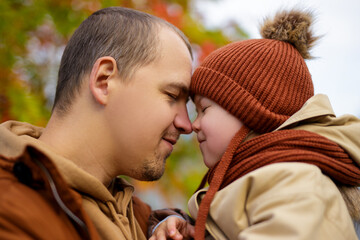 family and happiness concept - close up portrait of happy father and his little daughter in autumn park