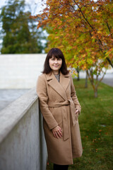 portrait of young woman posing in autumn park