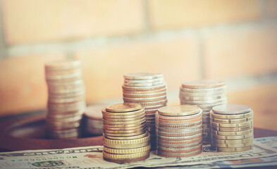 Coin stacks on a brick background