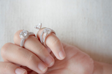 diamond rings on woman finger.love and an elegant wedding white gold ring concept