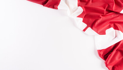 A beautiful Canada national flag cloth fabric, a sign or symbol of Canada day concept on white background.