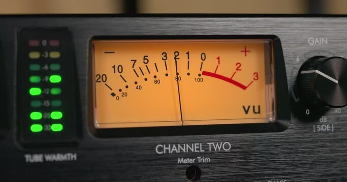 Close up of VU meter. Sound level indicator. Needles moving during recording. Professional studio audio equipment.