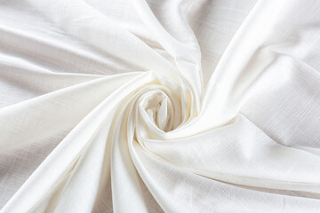 white linen fabric rolled into a spiral