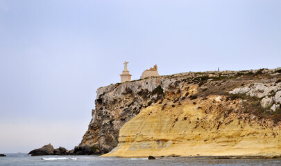 View of St Paul's Island and St Paul's Monument on the Rocks from a boat off the coast of Malta, Europe
