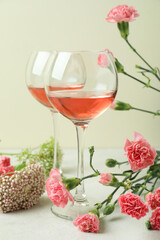 Glasses of pink wine and beautiful flowers