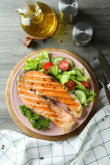 Concept of tasty eating with grilled salmon, top view
