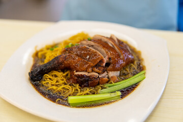 Roasted duck drumstick over noodle