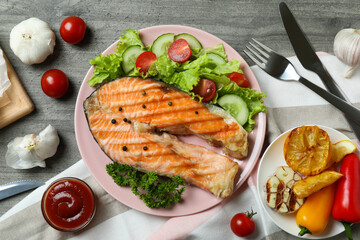 Concept of tasty eating with grilled salmon, top view