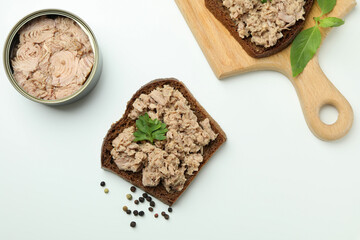Tasty tuna sandwiches on white background, top view