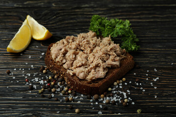 Sandwich with canned tuna on wooden background