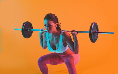 Woman training with barbells in the gym