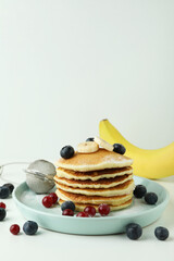 Concept of delicious food with pancakes on white table