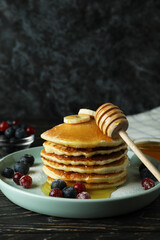 Concept of delicious dessert with pancakes on wooden table