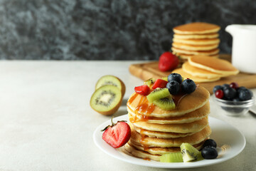 Concept of delicious dessert with pancakes on white textured table