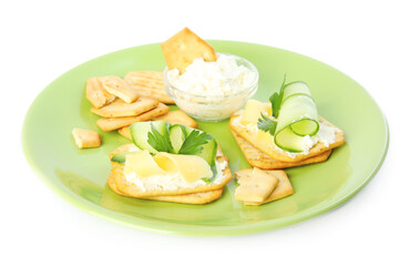Obraz na płótnie Canvas Delicious crackers with cream cheese, cucumber and parsley on white background