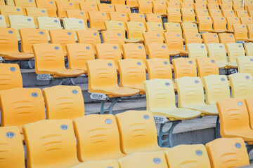 rows of yellow seats in a stadium