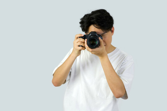 Dslr full frame camera in photographer's hand. Working atmosphere in the photo studio.