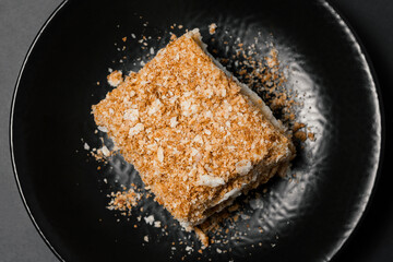 Honey cake on a black plate