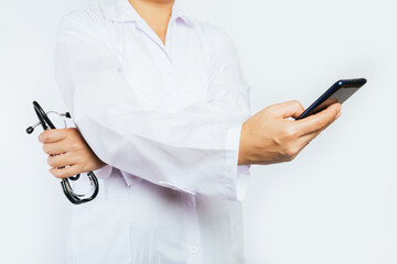 Image of a smartphone in the hands of a doctor with a stethoscope.