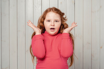 Portrait of surprised cute redhead preteen girl in awe, drop jaw and gasping amazed, stare at something unbelievable