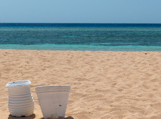 Fototapeta na wymiar Sunny day near sea with reef in Egypt. White pots