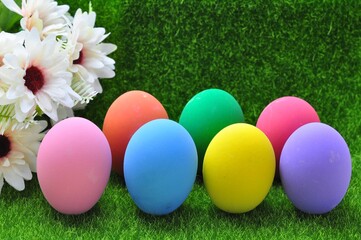 Fototapeta na wymiar Sweet colored Easter eggs on grass background