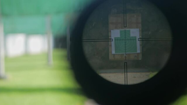 Optical sight of a sniper rifle, a green target at gunpoint. Sports shooting in the dash. outdoor