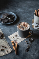 Cappuccino in a mug with cookies on background