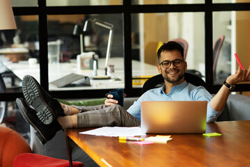 Portrait of handsome businessman in the office. Businessma on coffee break.