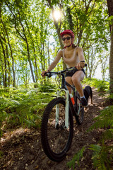 Fototapeta na wymiar pretty young woman mountain biking in nature