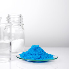 Close up inorganic chemical on white laboratory table. Copper(II) sulfate, Microcrystalline wax and...