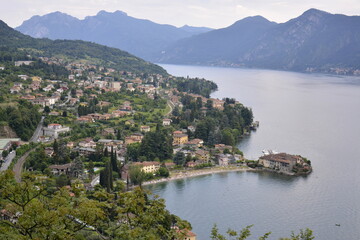 Fototapeta na wymiar Panorama of Lierna mountain lake Como surrounded by green hills covered with cedar forest