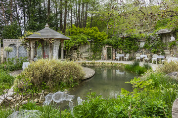 Fototapeta na wymiar Le Moulin Jaune (Yellow Mill) located on Grand Morin (Gran Morane) banks. Moulin Jaune - 4 ha gardens which conceals multiple works of art. Crecy la Chapelle, France. 