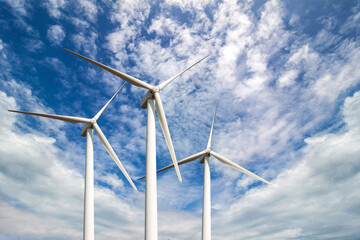 Wind turbine for electric power production under blue sky, green ecological power