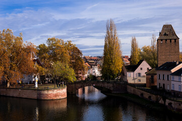 Fototapeta na wymiar Strasbourg silhouette with panorama view of river bridges and brick towers of the island and the church La Petite France, Strasbourg, Alsace, France