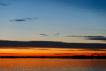 Fototapeta na wymiar Orange sunset on the river