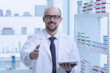 Naklejka na ściany i meble Pharmacist is working. Man wearing special medical uniform located in pharmacy.