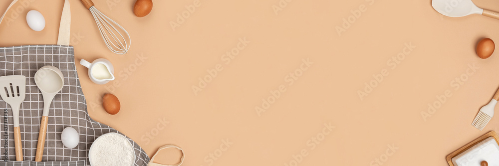 Wall mural banner made with baking ingredients and cooking utensil with copy space on light brown background. t