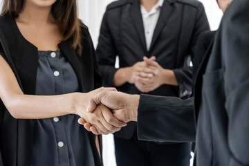 Obraz premium crop image of business people group handshake after finishing up business meeting in office, congratulation on promotion, partnership, success, partner, teamwork, community, connection concept