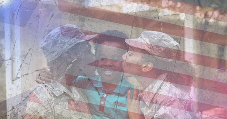 Composition of male and female soldiers kissing smiling son over american flag