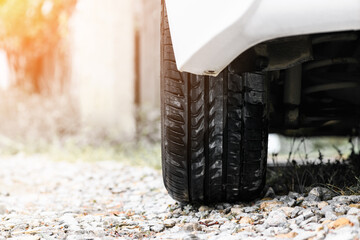 White car wheel on the road with yellow flare
